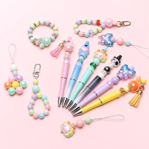 Detail of colorful DIY beaded pens with cute cartoon charms and matching accessories
