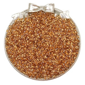 Amber glass seed beads for DIY jewelry displayed in a decorative silver tray