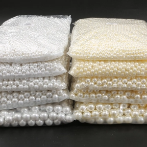 Bulk packs of glossy ABS faux pearls in white and cream white for DIY jewelry making
