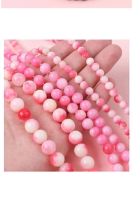 Macro view of polished pink agate beads showing natural marble textures and round shapes