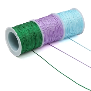 Close-up of vibrant jade green, purple, and blue braided nylon threads for DIY jewelry making