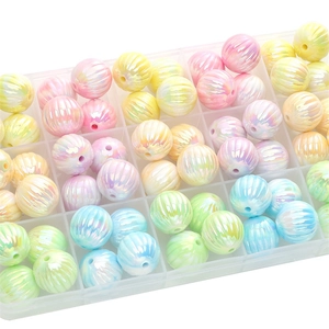 Macro shot of colorful striped acrylic beads for DIY jewelry in a clear storage box