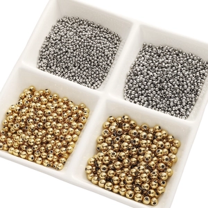 Close-up of gold and silver stainless steel round beads for DIY jewelry making