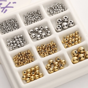 Detailed macro view of gold and silver polished stainless steel spacer beads for DIY jewelry