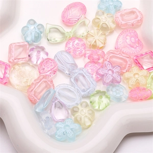 Macro shot of colorful acrylic mixed beads in pastel flower and star shapes for DIY jewelry