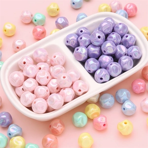 Irregular acrylic beads with rainbow AB coating for DIY jewelry making in a white plate