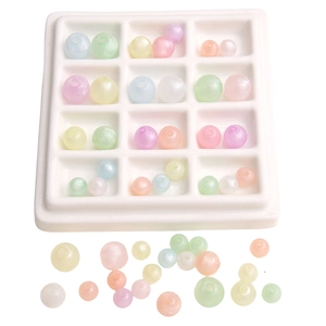 Mix of luminous macaron acrylic round beads in 12-grid organizer for DIY jewelry making