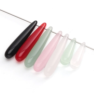 Detailed view of long teardrop resin beads in various colors with pre-drilled holes