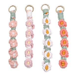 Handmade crochet daisy flower keychains in pastel colors with golden metal ring clasps