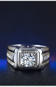Macro shot of men's silver ring with central zircon and square halo setting on blue background