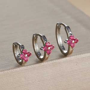 Three-piece silver clover earrings set with vibrant magenta cubic zirconia accents