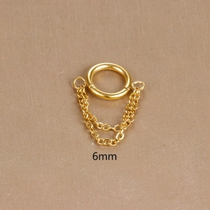 Detail of 6mm gold stainless steel hoop earring featuring a double chain tassel design