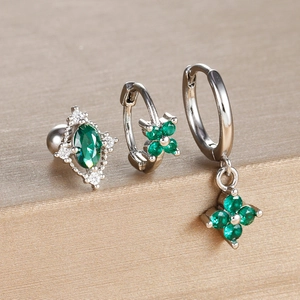 Detailed view of three-piece silver clover earring set with emerald green zircon stones