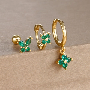 Detailed set of gold four-leaf flower earrings with emerald green zircons on brushed metal
