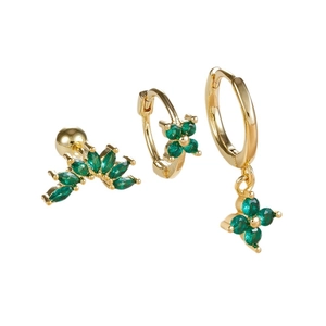 Three-piece gold flower earring set with green emerald marquise stones on white background