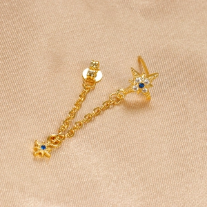 Detailed view of gold chain star earrings featuring blue zircon and sparkling accents