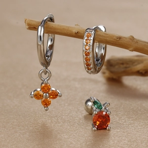 Detailed set of silver hoop earrings with orange clover and apple-shaped zircon studs