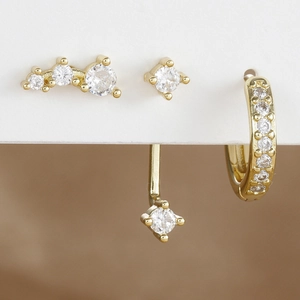 Set de tres pendientes bañados en oro con piedras de circonita y diseño climber elegante