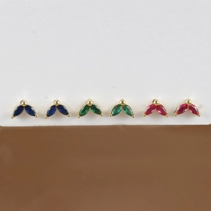 Detail of gold plated marquise cut zircon flower earrings in blue, green, and rose pink