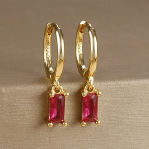 Macro detail of S925 hallmark on gold plated earring with red rectangular zircon drop