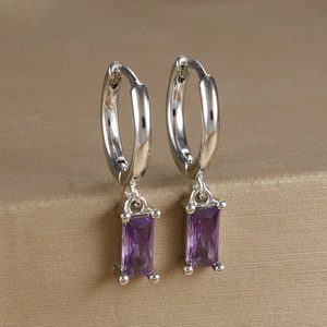 Detail shot of purple rectangular zircon earring with silver plating on gold silk