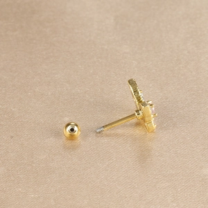 Detailed shot of bow-shaped stud earring with pink and white cubic zirconia stones