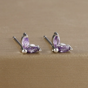 Close-up of luxury flower stud earrings with purple marquise zirconia in silver plating