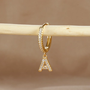 Detailed close-up of a gold-plated letter A earring with micro-pave cubic zirconia accents