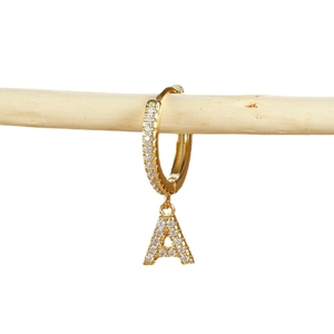 Gold letter A earrings with micro-pave cubic zirconia on a minimalist wood branch