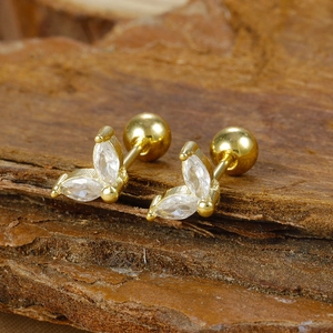 Macro view of gold plated leaf stud earrings with marquise zircons and ball back closure