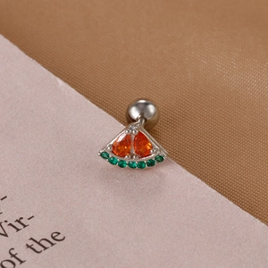 Macro detail of watermelon stud earring with orange zircon and green stones