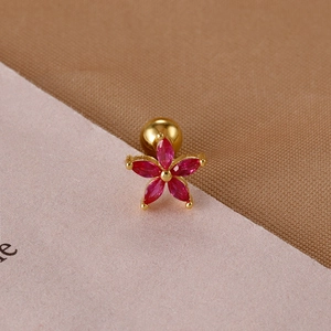 Detail of red flower cartilage stud earring with cubic zirconia and gold screw back