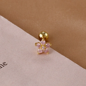 Detailed macro view of pink zircon flower stud earring with gold screw ball back
