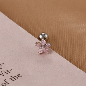 Close-up of pink zircon flower earring with silver screw back and polished metal finish