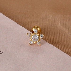 Macro shot of gold stainless steel star cartilage stud with cubic zirconia and screw back