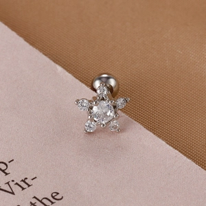 Macro shot of silver star cartilage stud featuring clear zircons and a screw back ball