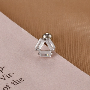 Macro shot of triangle stud earring with three clear rectangular zircons and screw back