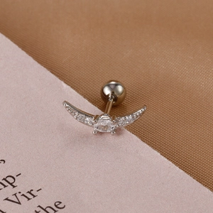 Macro shot of silver crescent wing barbell stud earring with clear zircon and screw-back ball