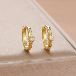 Elegant gold-plated huggie hoop earrings featuring a sunburst zircon pendant and starburst design