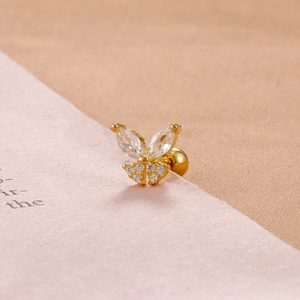 Detailed close-up of a gold butterfly stud earring with clear marquise-cut zircons