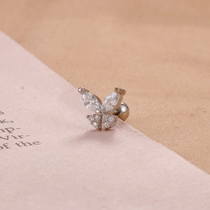 Macro shot of silver butterfly stud earring with clear marquise-cut cubic zirconia crystals