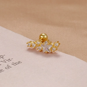 Macro detail of a gold-plated star helix stud with cubic zirconia and screw-back