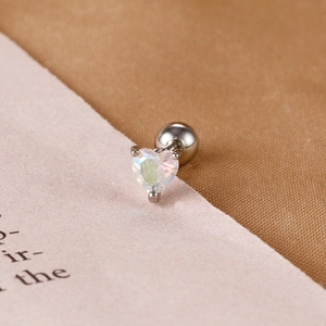 Macro detail of heart-shaped opal cartilage stud with three-prong setting and ball back