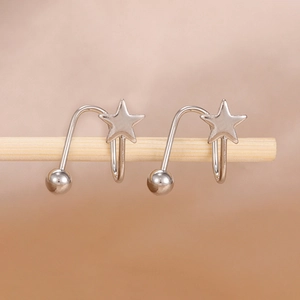 Macro detail of silver star stud earrings with a polished finish and U-shaped design
