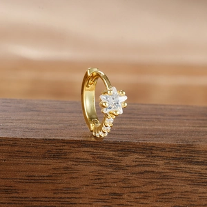 Golden huggie hoop earring with star-shaped cubic zirconia and micro-pave detailing