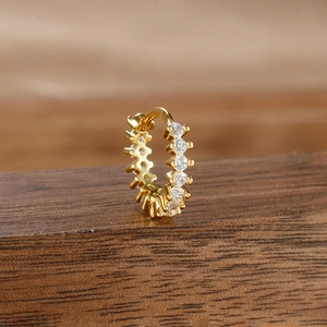 Detailed close-up of a gold-plated hoop earring with micro-pave white zircon stones