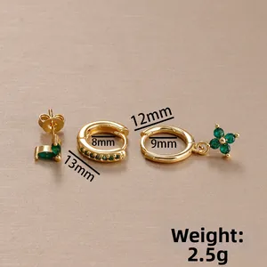 Detail view of gold flower earrings with green zircon and 2.5g weight specification