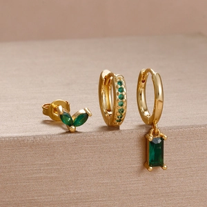 Three-piece gold flower earring set featuring emerald green leaf and square gemstones