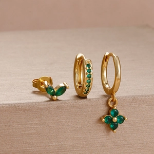 Three-piece gold flower earring set featuring green marquise gemstones and drop pendants