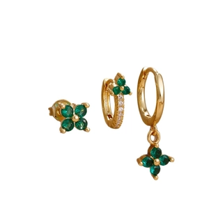 Three-piece gold flower earring set with green emerald stones in a minimalist style